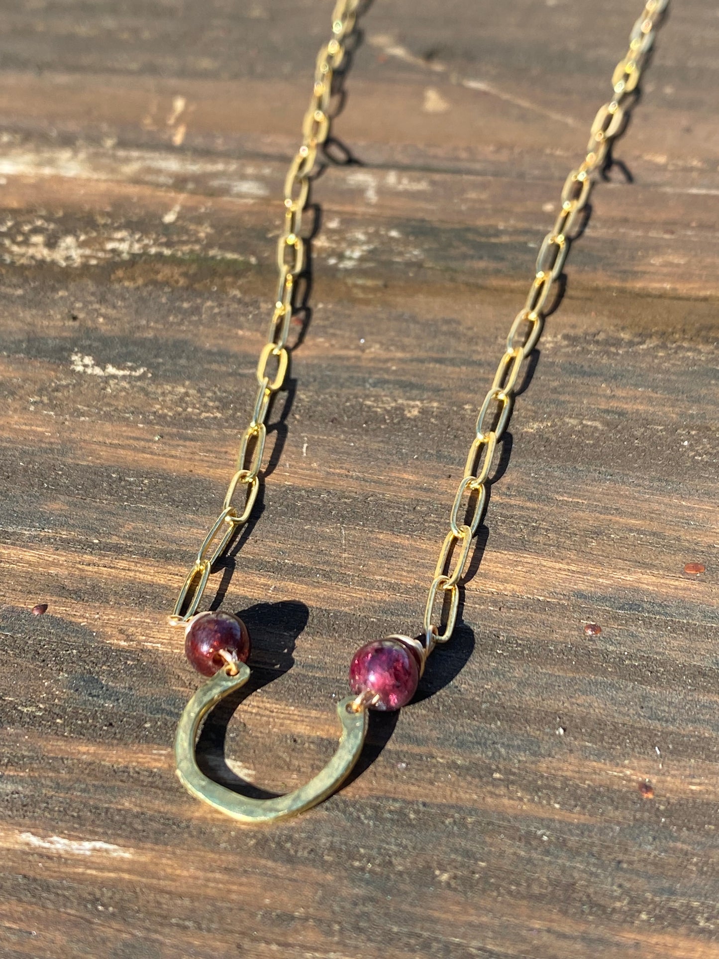 horseshoe and garnet bar necklace