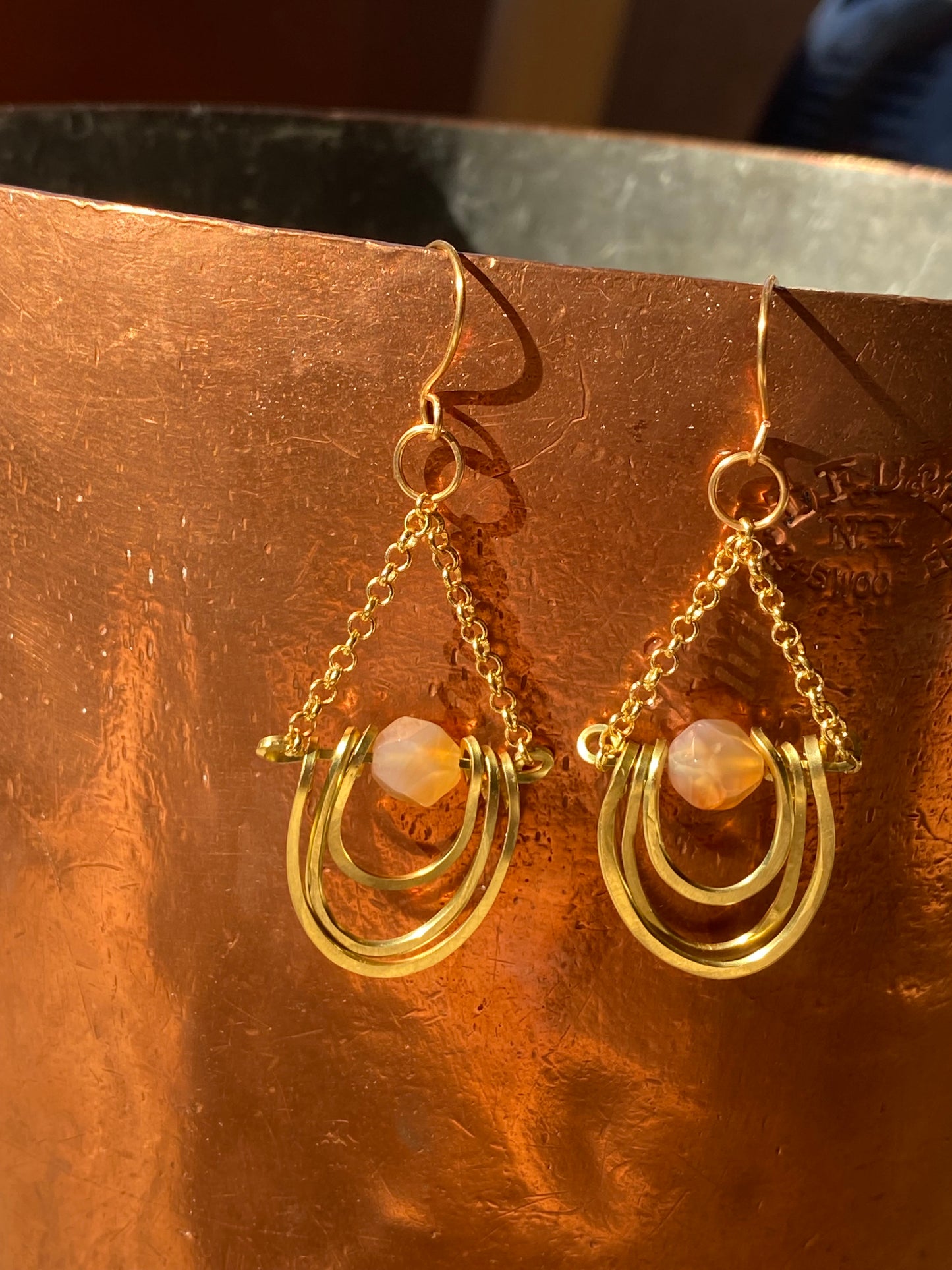 layered horseshoe and sunstone dangles