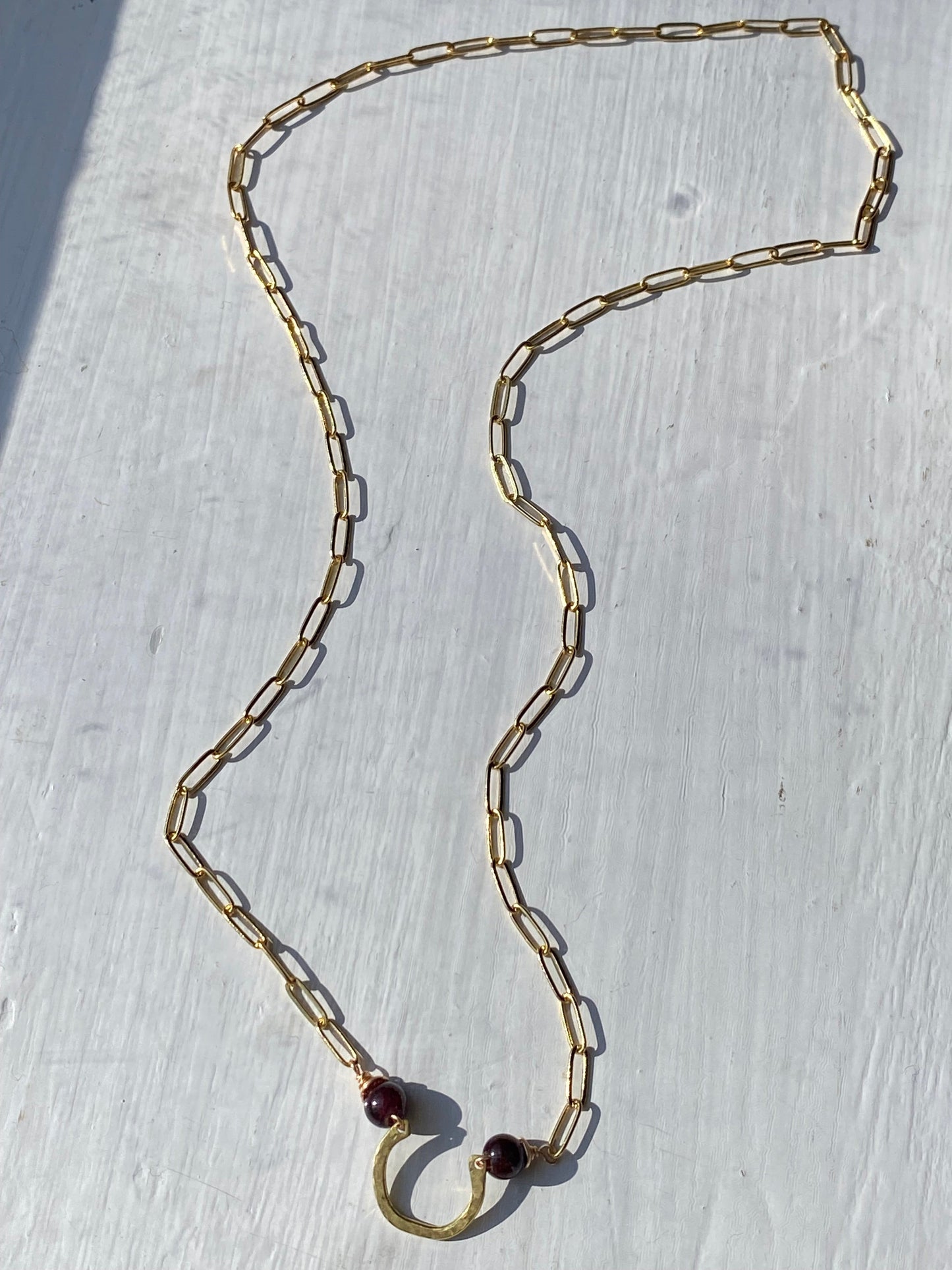 horseshoe and garnet bar necklace