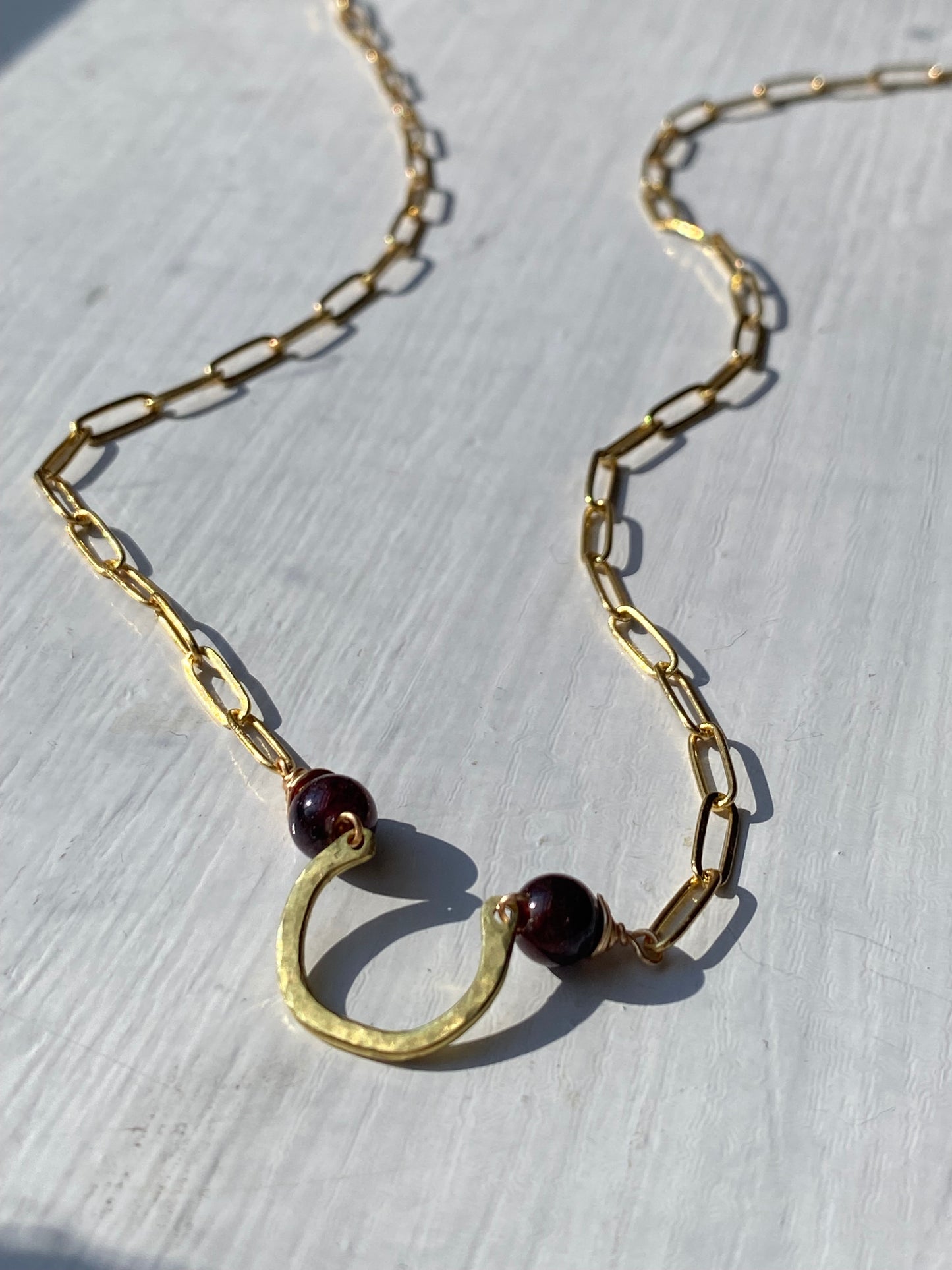 horseshoe and garnet bar necklace